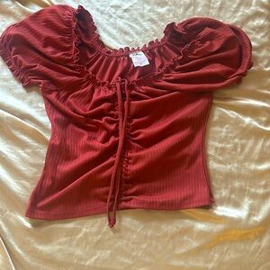 Looks cute with jeans not quite red more of a burgundy and only worn once.